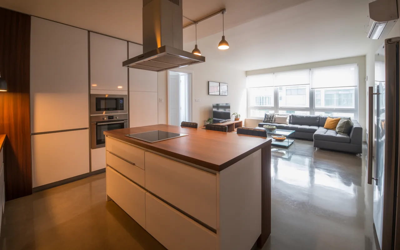 Small combo space with a kitchen island separating kitchen and living zones.