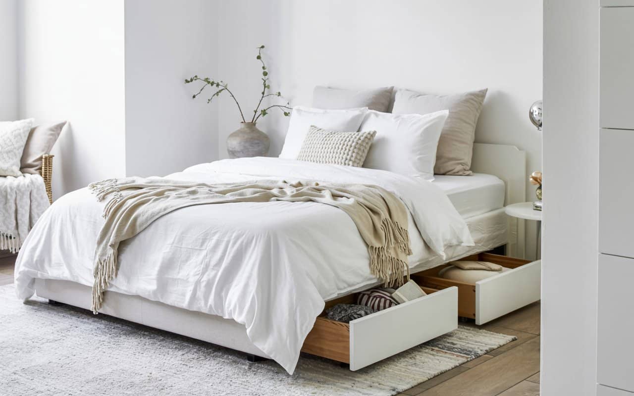 White minimalist bedroom with simple vase on side table, soft bedding, neutral décor, cozy elegant interior, Pinterest-style photography.
