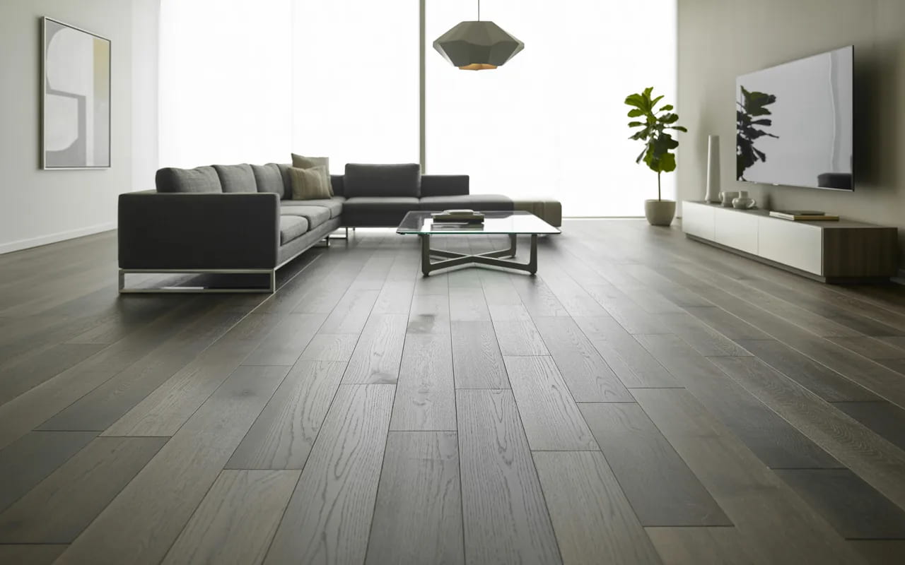 Modern living room with trendy grey wide plank flooring and minimalist furniture.