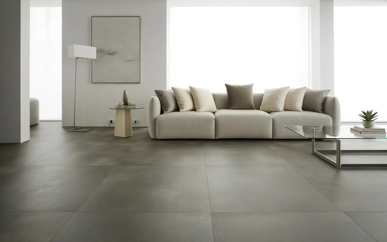 Living room with grey flooring, neutral sofa, and minimalistic decor.