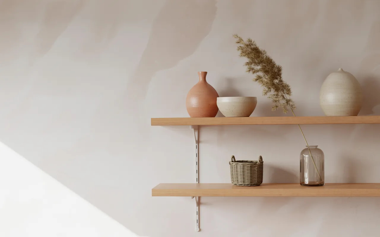Minimal shelves with a few handmade decor pieces and neutral styling.