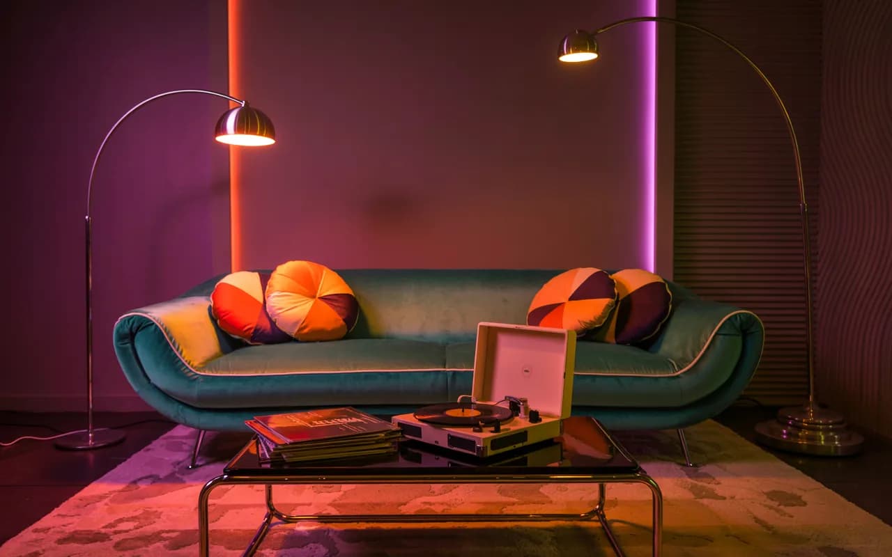 2000s-inspired living room with neon lights, LED strip lights, curved floor lamp, cozy retro-modern ambiance”