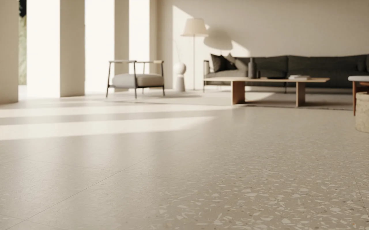 Minimalist living room with terrazzo flooring, white walls, and simple furniture.