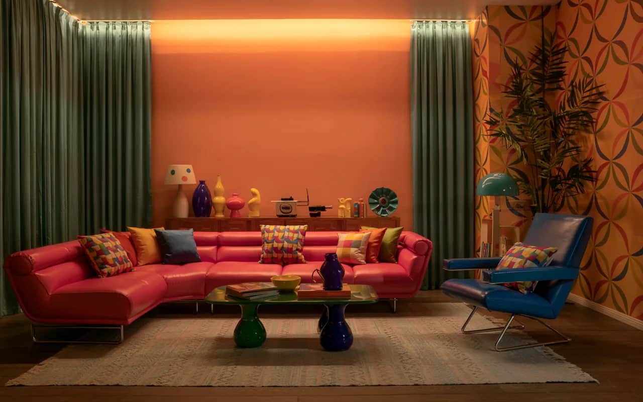“880s Living Room Retro Vintage with neon pink sofa, electric blue armchair, colorful cushions, bright accent wall, retro decorative items