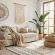 Modern boho living room with neutral tones, woven textures, plants, cozy sofa, natural light, relaxed chic interior design