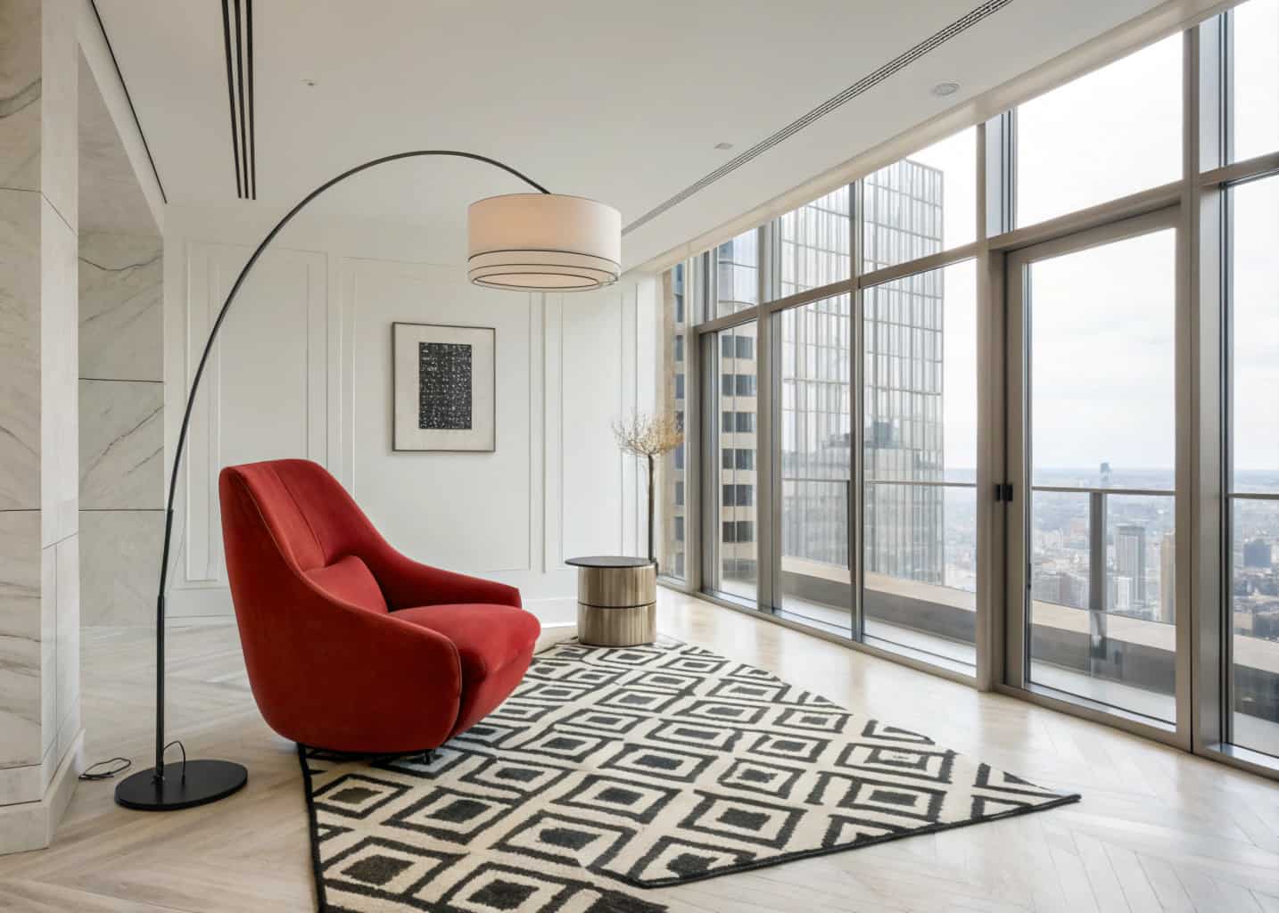 “Stylish high-rise apartment living room with a bold red armchair, geometric rug, sculptural floor lamp, minimal décor”