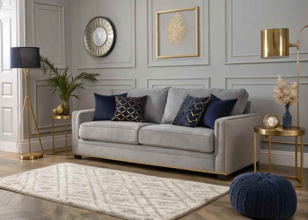 Modern grey living room with grey sofa, cream rug, navy blue cushions, gold accents, cozy and elegant atmosphere