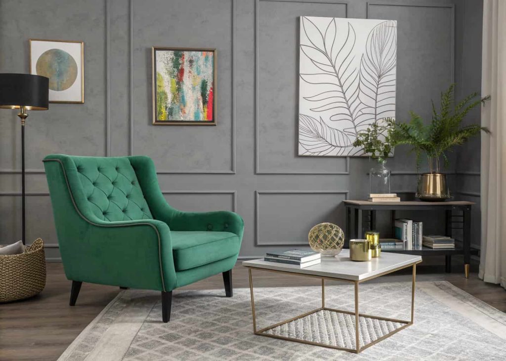 Grey living room with bold green armchair, modern coffee table, abstract wall art, contemporary stylish interior.