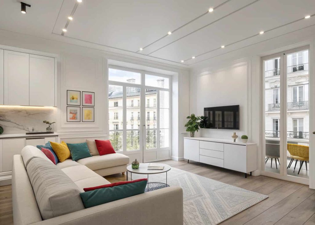 Neutral minimalist apartment living room with white walls and colorful cushions adding soft contrast