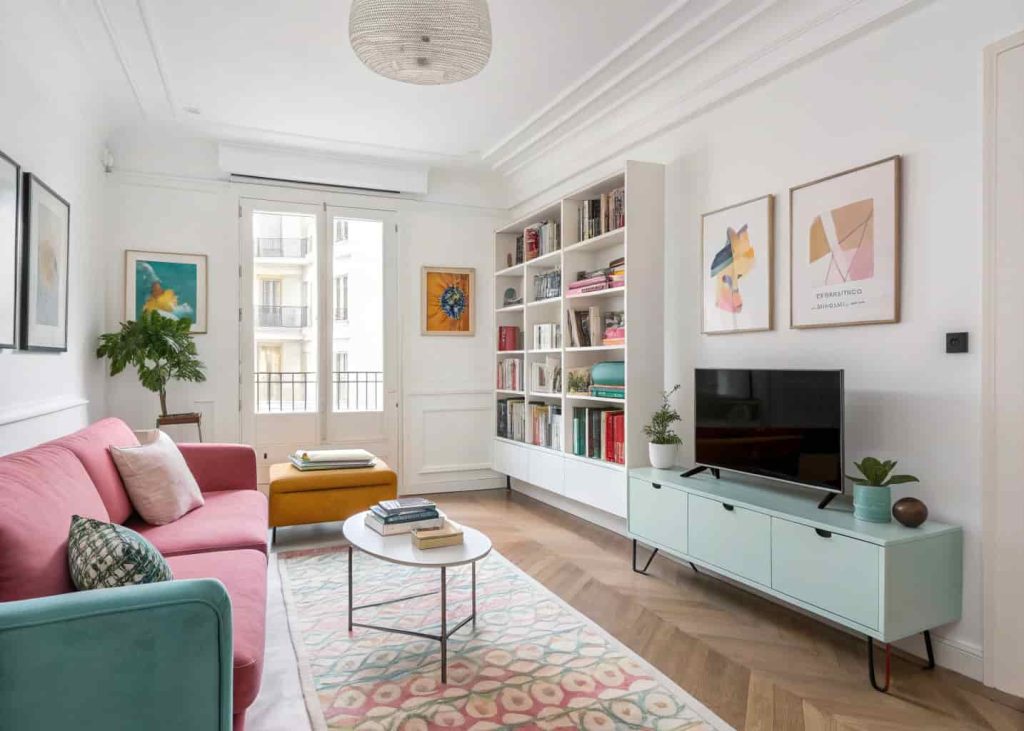 Personalized colorful minimalist living room apartment with curated decor, books, and modern artistic accents