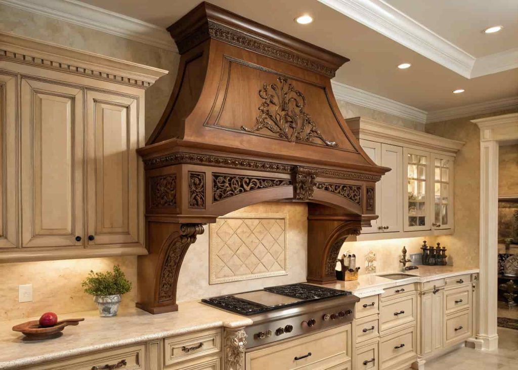 Classic kitchen with carved wooden range hood cover, decorative moldings, and traditional cabinetry