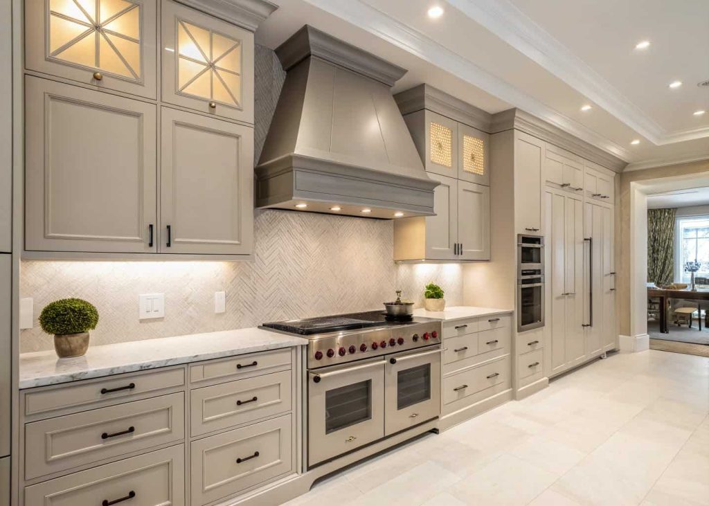 Custom built-in range hood integrated with kitchen cabinets in a modern elegant kitchen