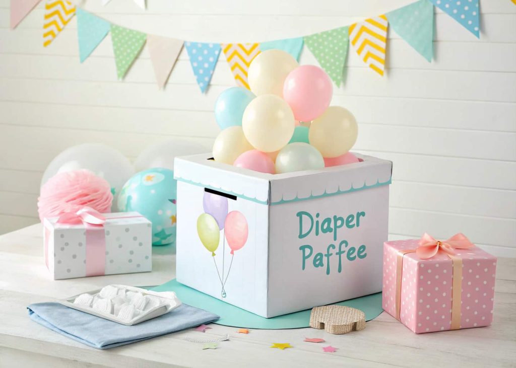 “Baby shower diaper raffle box, decorated with pastel balloons, small gift for winner, fun interactive setup.”