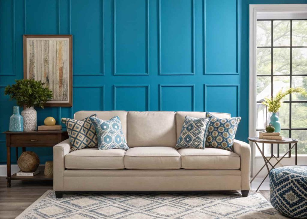 A room with a bold colored feature wall behind a sofa