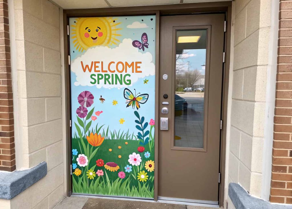 Door with a cheerful spring garden scene, flowers, butterflies, and “Welcome Spring” sign, layered and colorful.