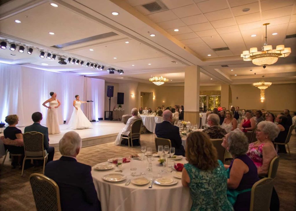 Wedding guests watching a surprise dance performance in the reception hall.