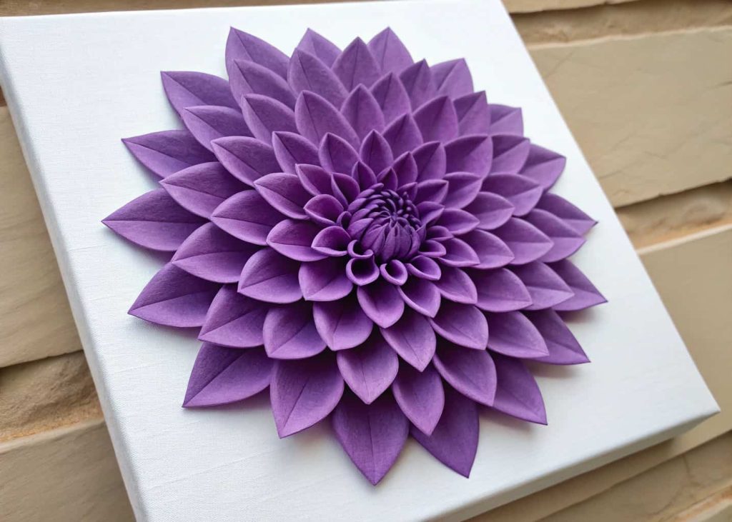 A handmade deep purple tissue paper dahlia with symmetrical pointed petals, mounted on a white canvas, geometric and elegant, flat lay photography with soft shadows.