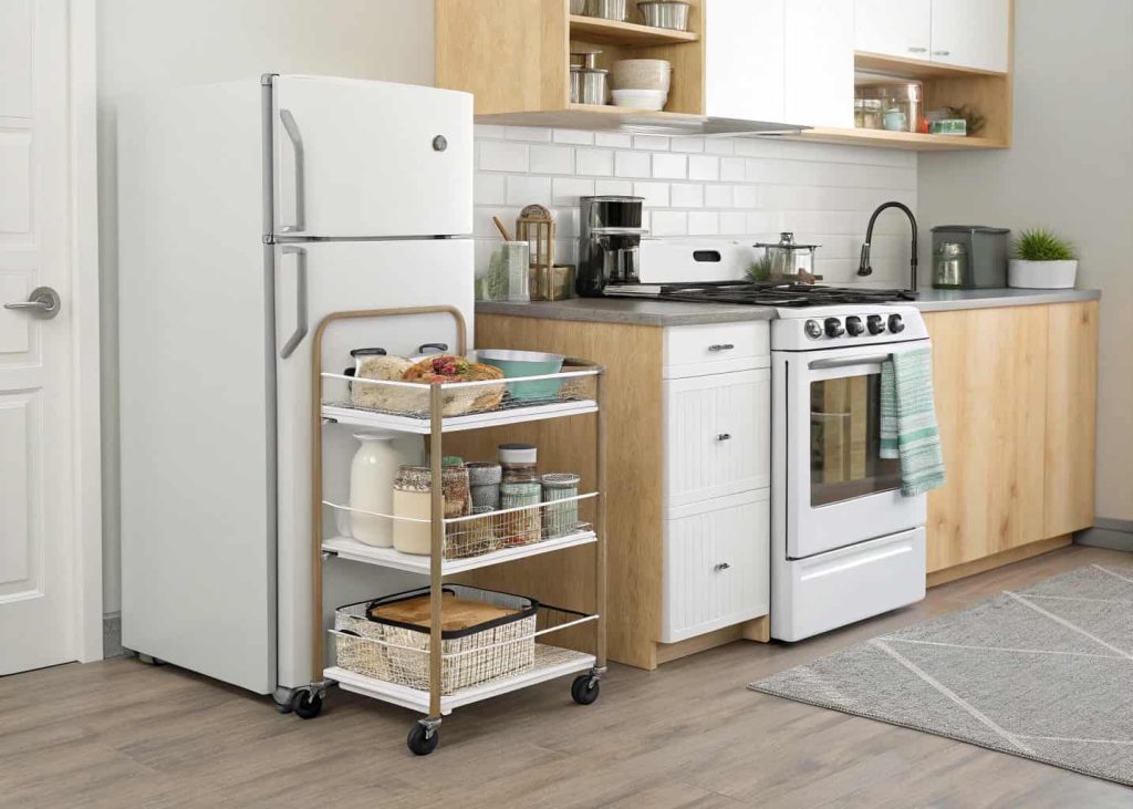 Small kitchen with a movable rolling cart used for storage
