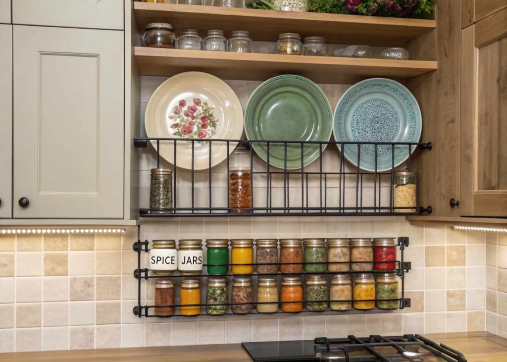 Kitchen wall with mounted racks holding plates and spices