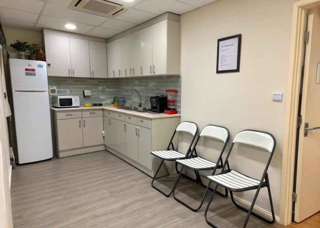 Small kitchen with foldable chairs stored neatly against the wall
