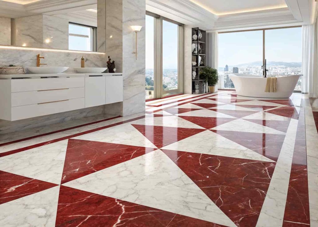 Red and white marble contrast flooring in a modern luxury bathroom with polished finish and natural light.