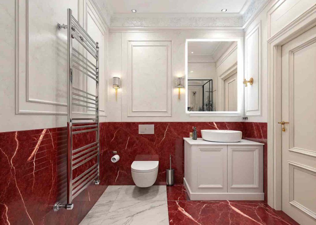  Red marble half wall bathroom design with white painted upper walls for a balanced luxurious look.