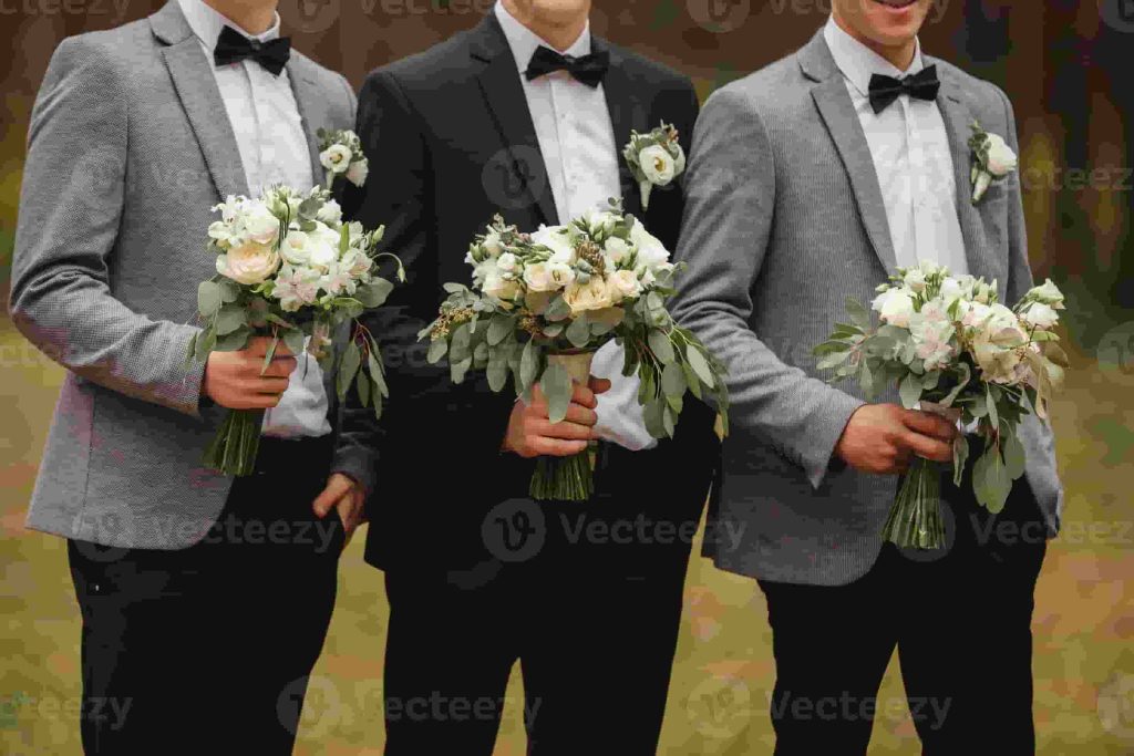 Hand-tied bridal bouquet of sweet peas and ranunculus held close in warm morning light