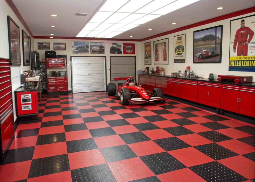 A racing-themed luxury garage with red and black checkered floors, professional tool cabinets, and a sports car displayed in the center.