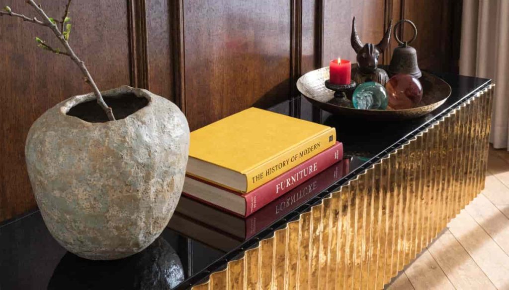 Large console table styled with oversized decor and a grouping tray