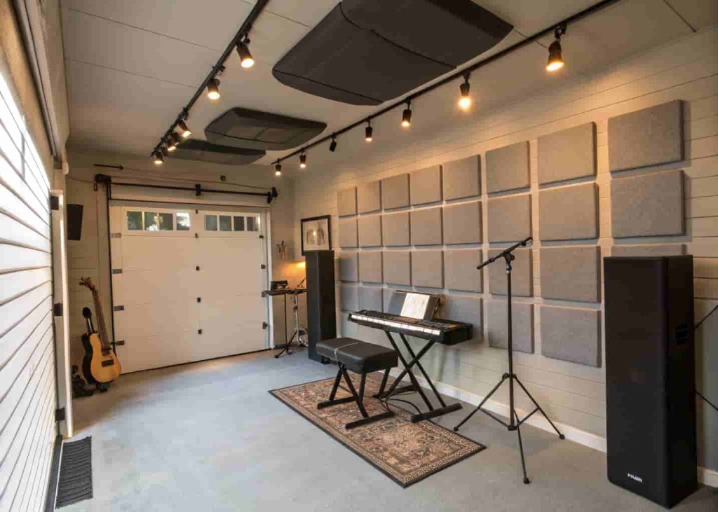 Garage music lesson studio with acoustic panels, keyboard, and professional lighting setup for teaching.