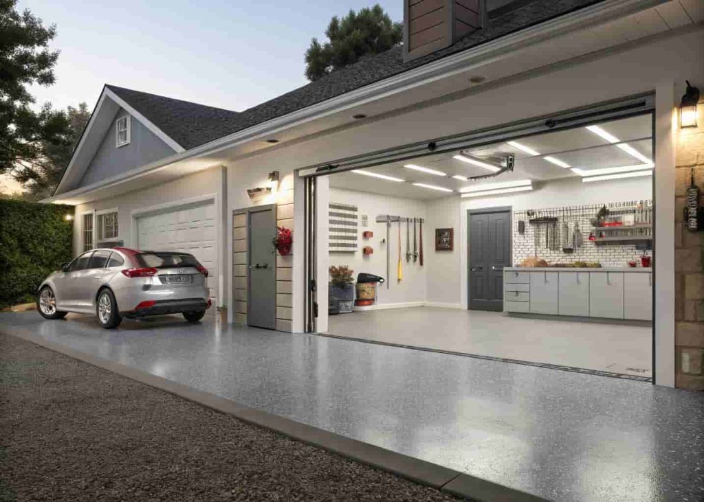 inished garage with shiny gray epoxy floor coating and organized wall-mounted tools