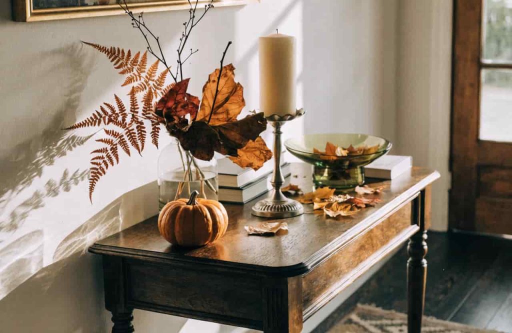 Console table decorated with seasonal autumn-themed items
