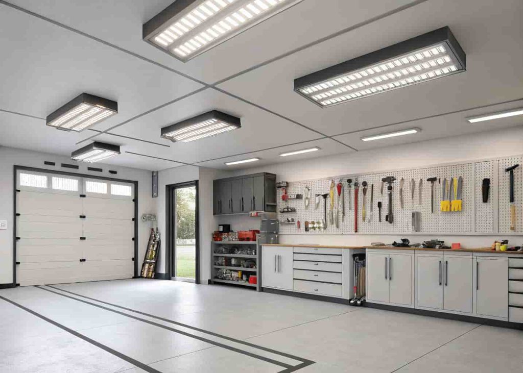 Garage interior with bright LED shop lights mounted on ceiling providing even illumination throughout