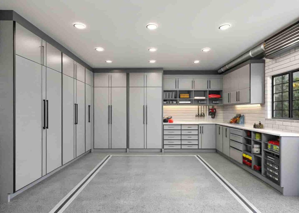 Garage wall lined with gray steel floor-to-ceiling storage cabinets in a clean organized residential garage