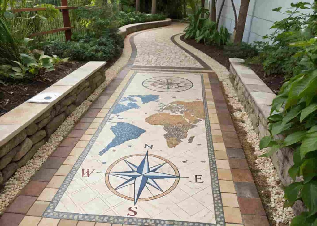 Vintage world map mosaic garden path in blue and beige tiles with compass rose design and stone borders