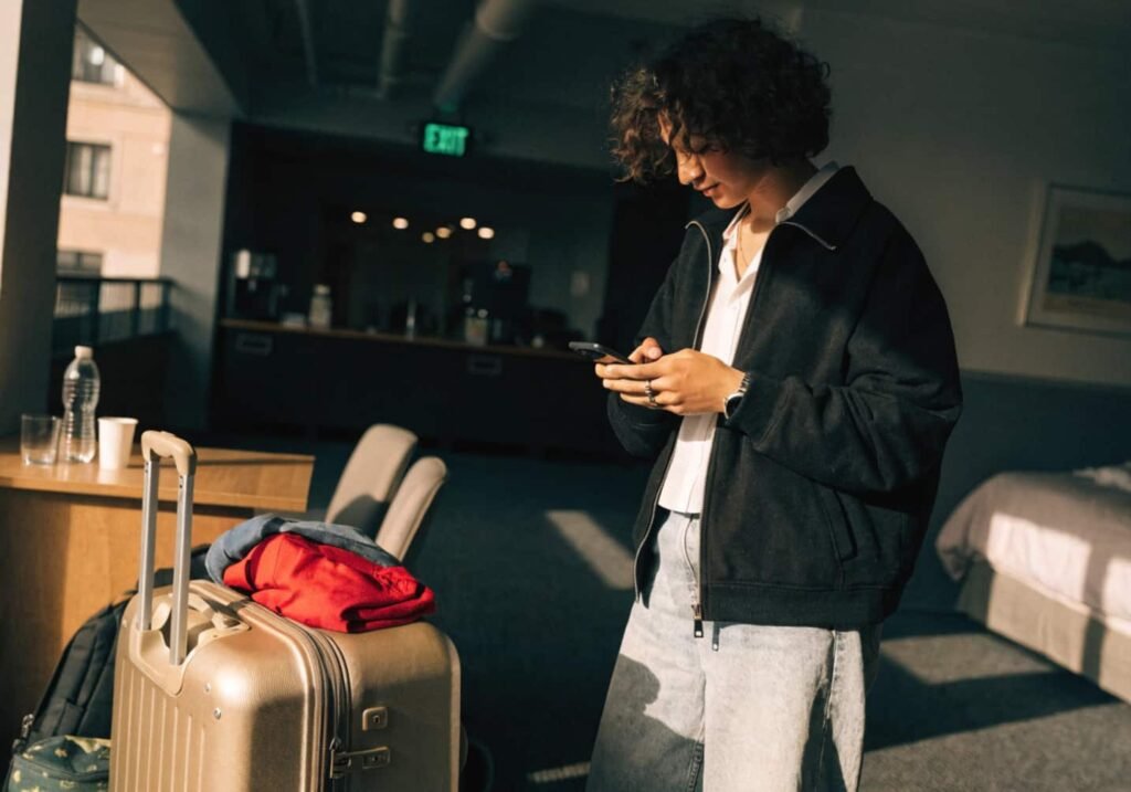 Traveler standing calmly next to a well packed suitcase before a trip