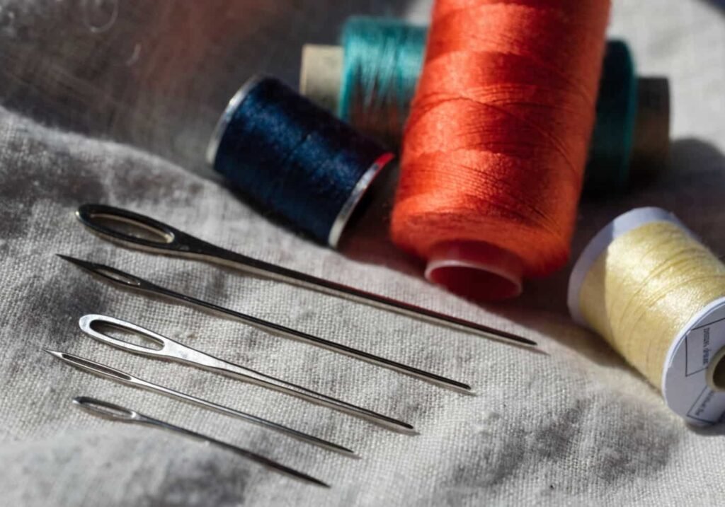 Various embroidery needle and thread sizes compared on fabric for beginners