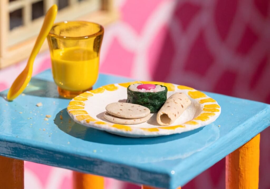 Miniature clay food plate with tiny pancakes and sushi pieces