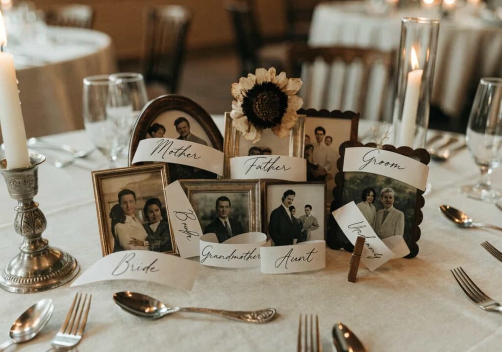 Wedding table decorated with framed family photos and handwritten place cards