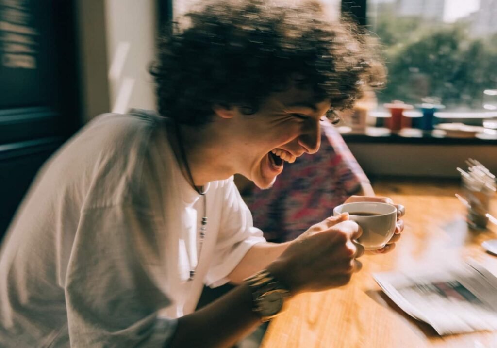 Genuine laughing over coffee candid aesthetic cafe photo