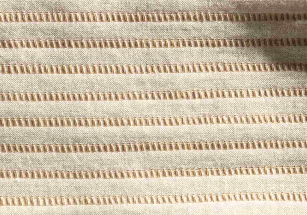 Consistent stitch direction and spacing shown on embroidery fabric sample