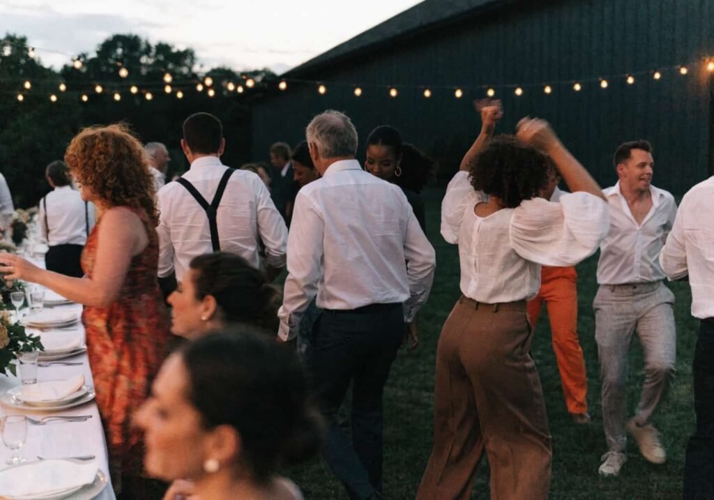 Guests moving from dinner to the dance floor during a wedding reception
