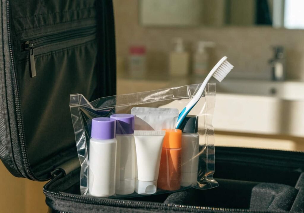 Clear toiletry bag packed with travel-sized essentials for a trip.