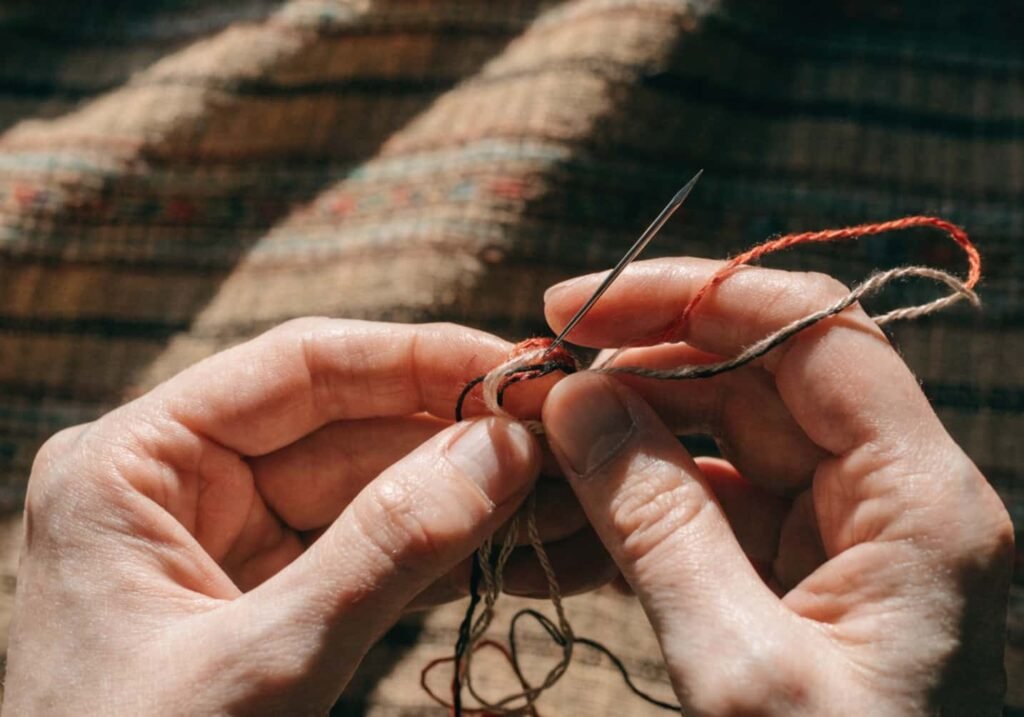Preventing thread tangles while embroidering with needle and fabric