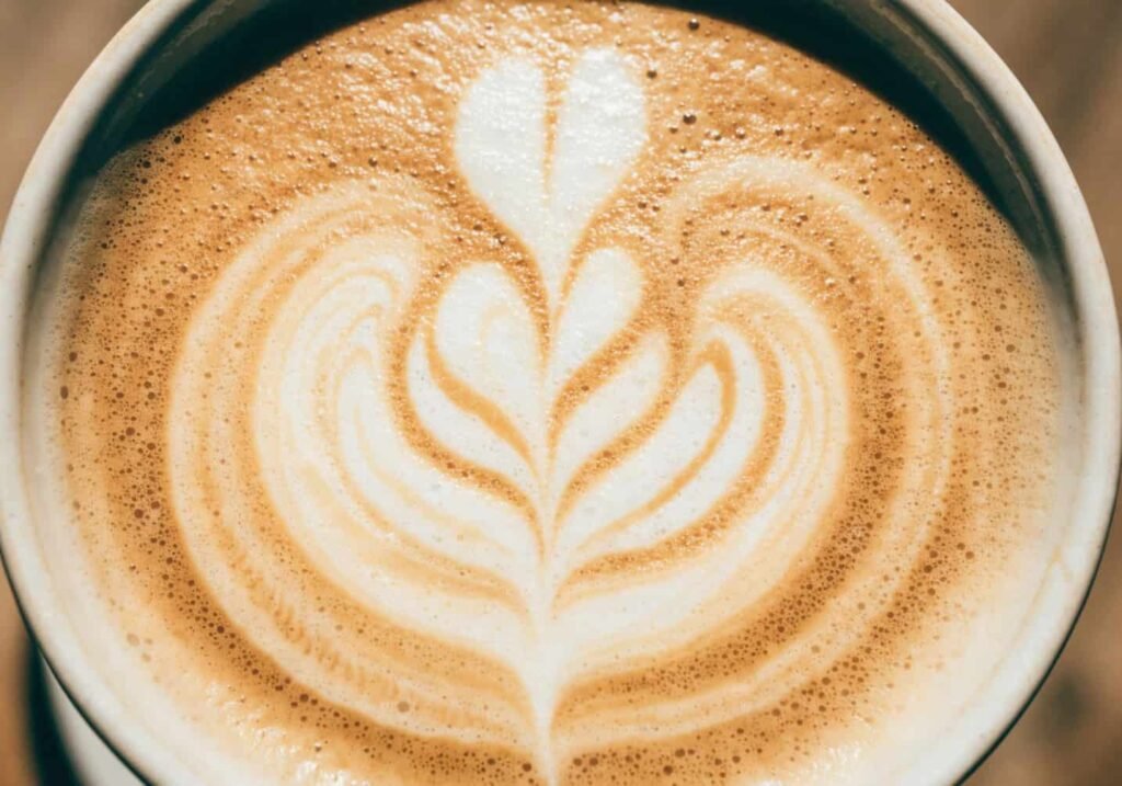 Latte art close-up aesthetic coffee cup photo from above