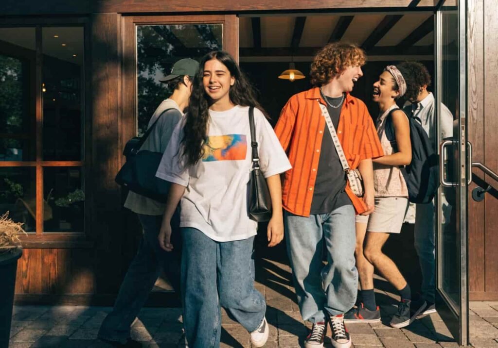 Group of friends walking together into a cafe.