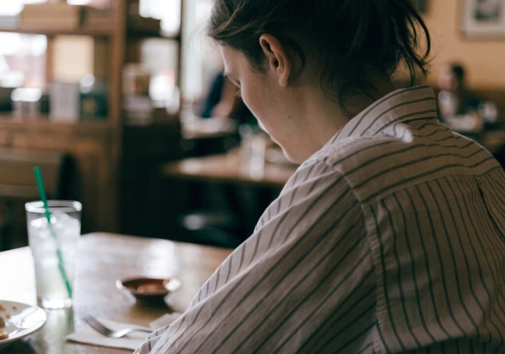 Over-the-shoulder candid shot of a person at a cafe