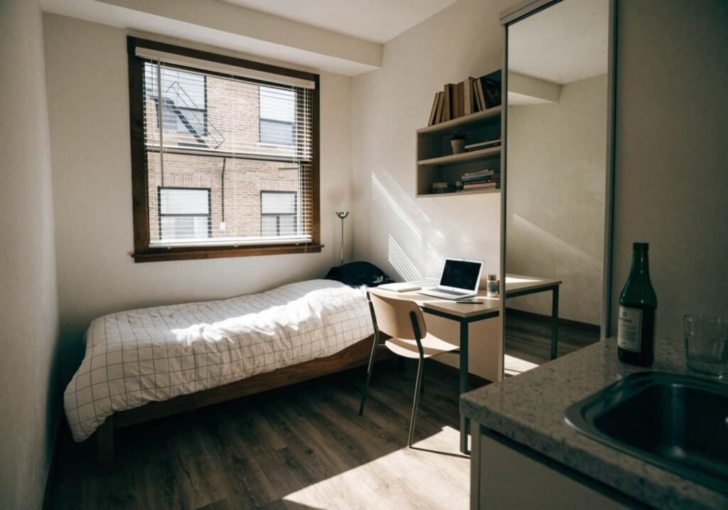 Slim chrome floor lamp fitting neatly into a small studio apartment corner