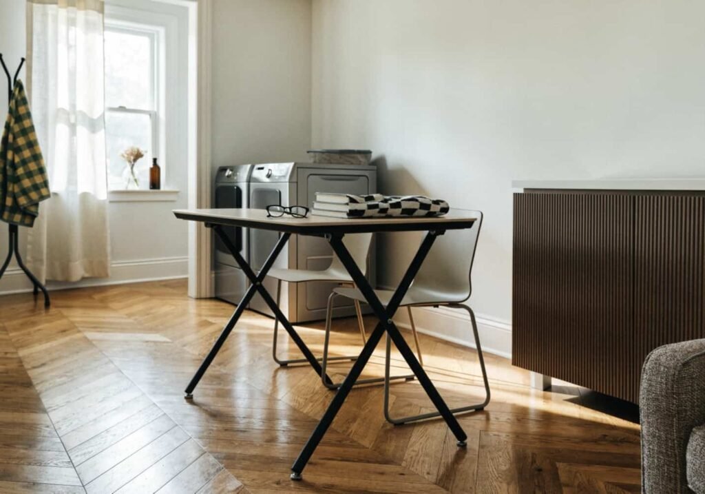 Matte black frame folding table in a modern laundry room
