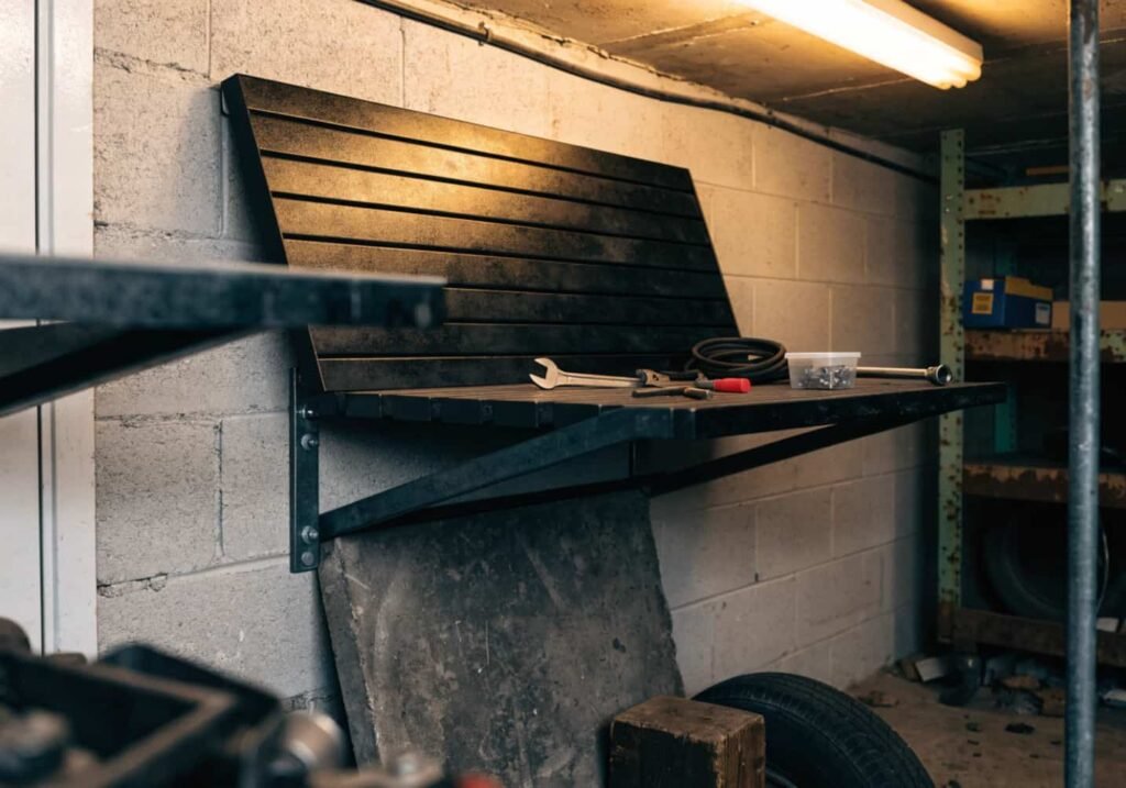 Wall-hinged folding table used as a garage workbench